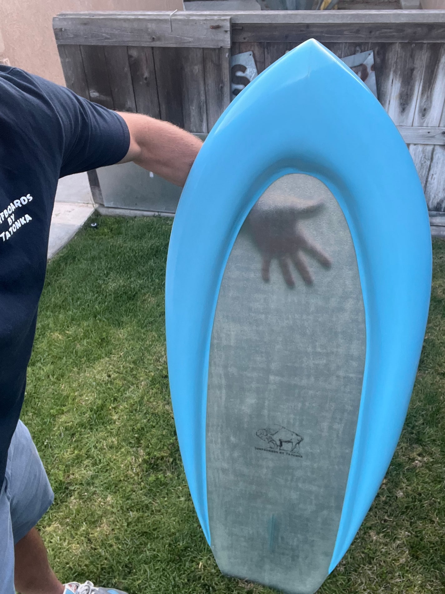 Blue Tatonka board with a translucent center held outdoors
